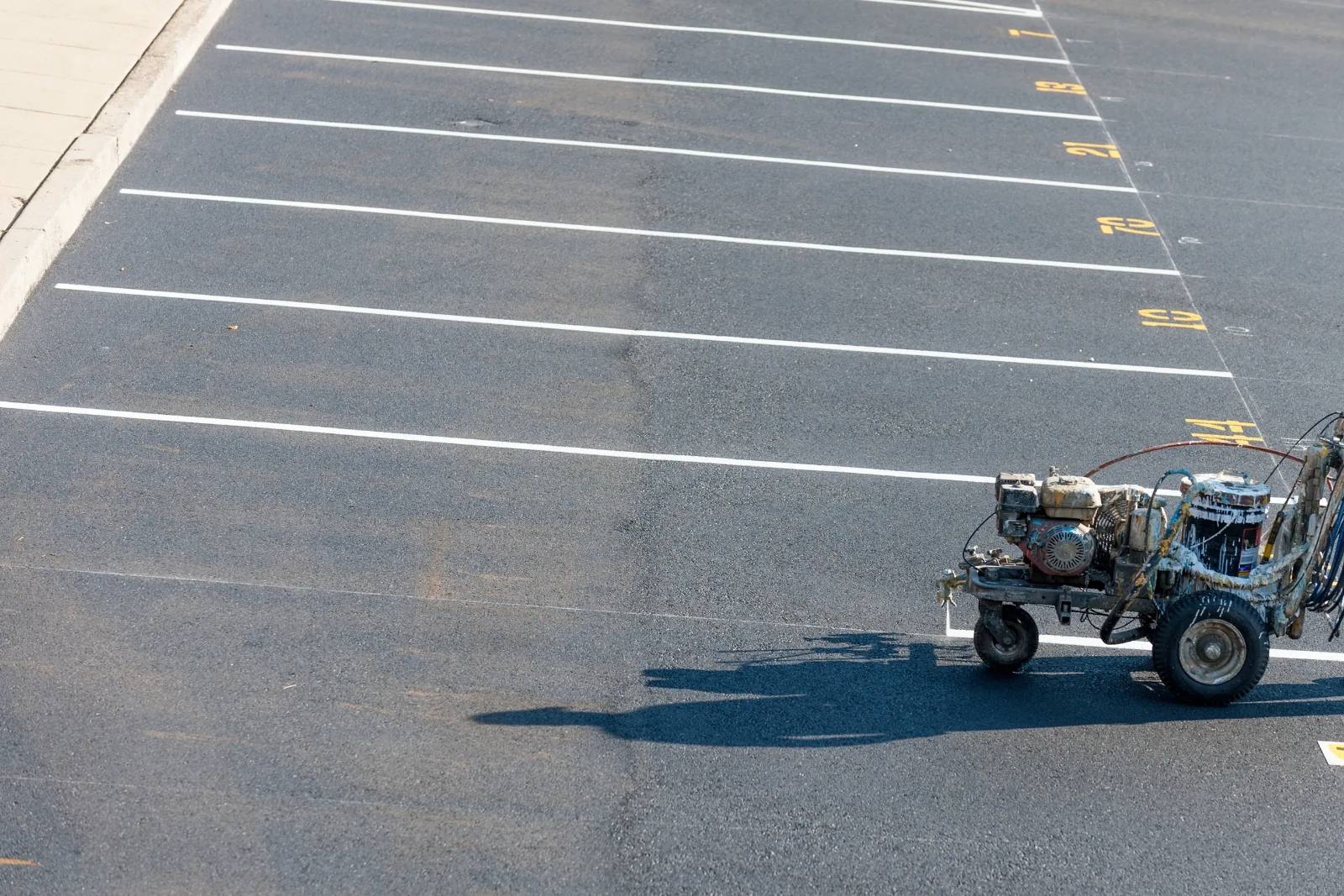Parking lot striping equipment in use